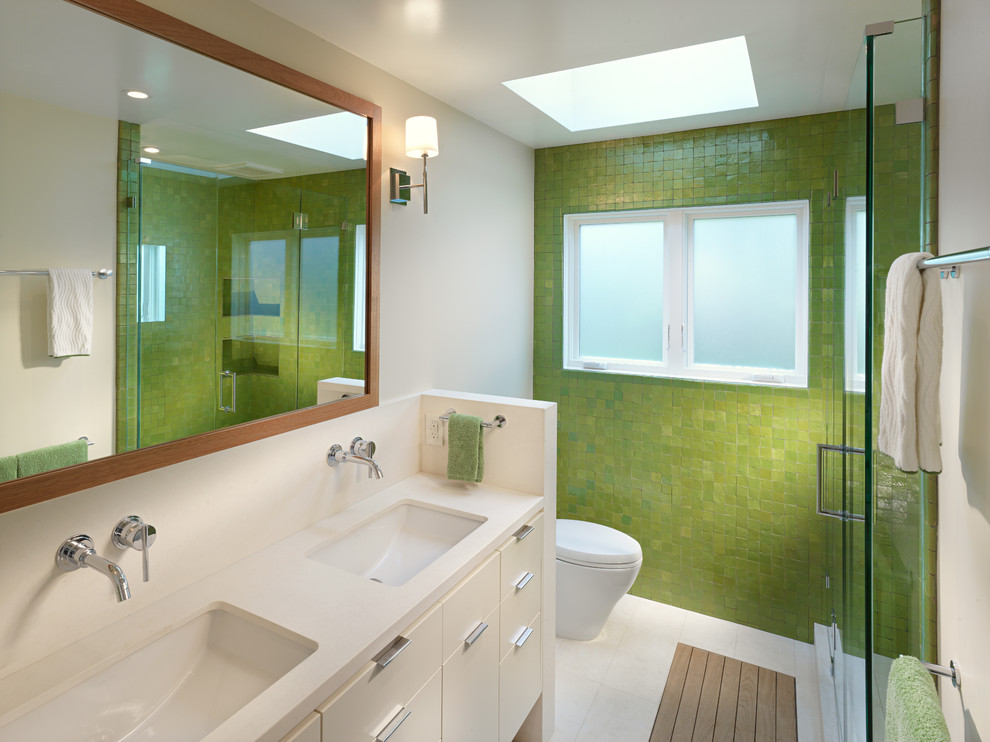 Inspiration for a contemporary bathroom in San Francisco with an undermount sink, flat-panel cabinets, white cabinets, an alcove shower, green tile, mosaic tile and green walls.