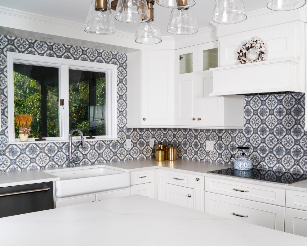 Eat-in kitchen - mid-sized transitional l-shaped medium tone wood floor and brown floor eat-in kitchen idea in St Louis with a farmhouse sink, recessed-panel cabinets, white cabinets, quartz countertops, blue backsplash, ceramic backsplash, stainless steel appliances, an island and white countertops