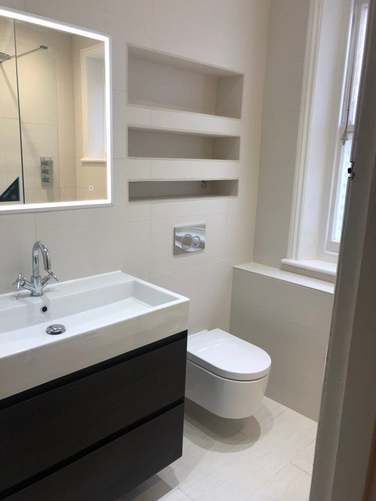 Design ideas for a mid-sized contemporary master bathroom in London with flat-panel cabinets, dark wood cabinets, an open shower, a one-piece toilet, gray tile, porcelain floors, an integrated sink, terrazzo benchtops, an open shower, white benchtops, a single vanity and a floating vanity.