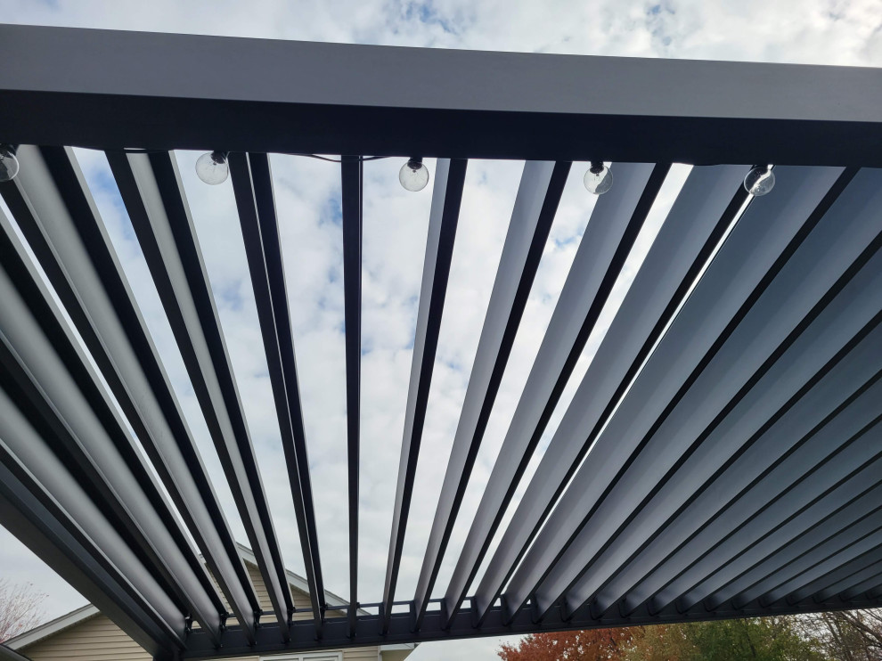 Deck - large backyard ground level metal railing deck idea with a pergola