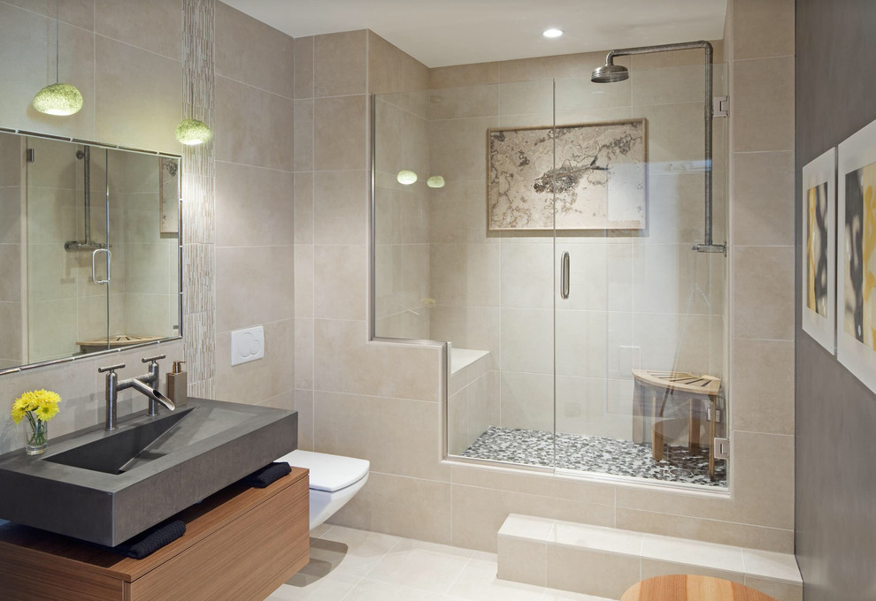 Transitional 3/4 beige tile alcove shower photo with an integrated sink, flat-panel cabinets, medium tone wood cabinets and a wall-mount toilet