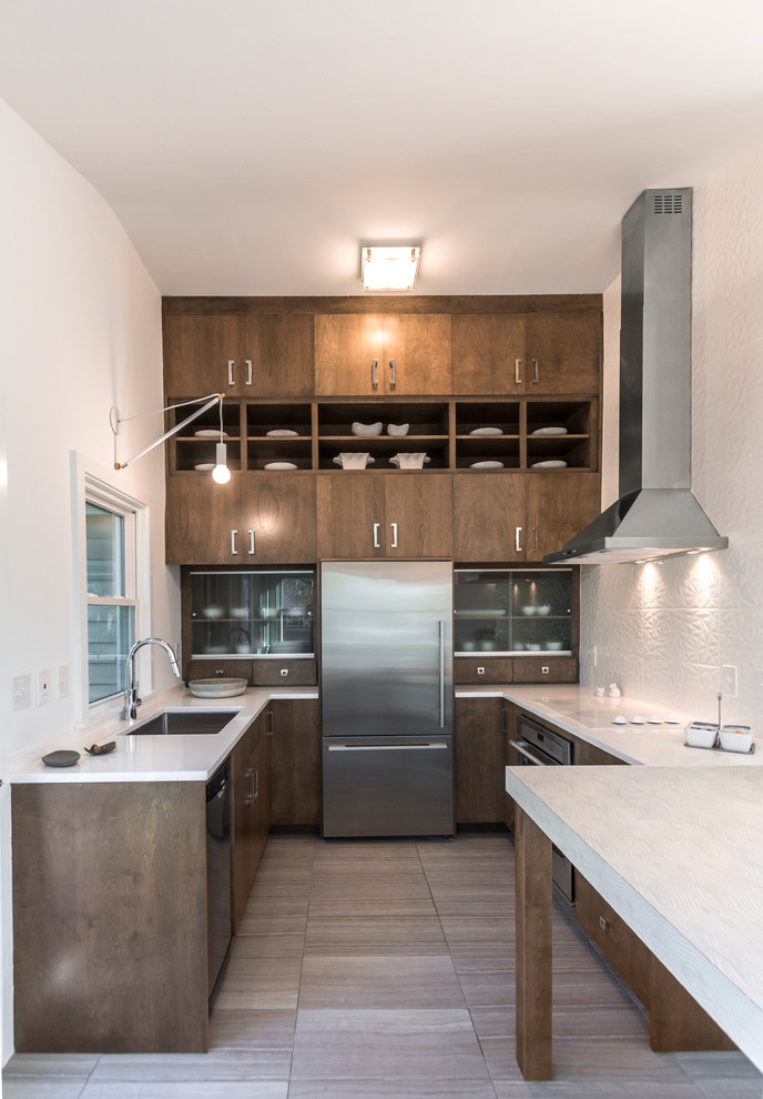 Design ideas for a mid-sized contemporary u-shaped separate kitchen in Minneapolis with an undermount sink, quartz benchtops, white splashback, stainless steel appliances, porcelain floors, grey floor, flat-panel cabinets and dark wood cabinets.