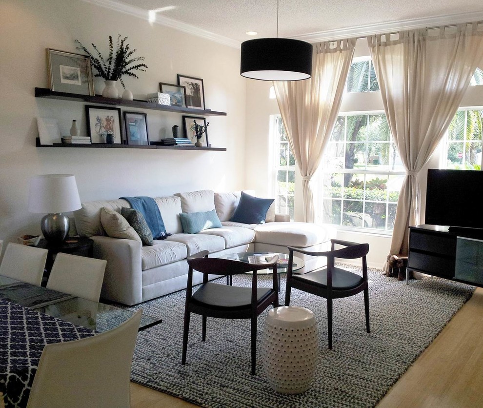 Inspiration for a small coastal open concept bamboo floor living room remodel in Tampa with white walls, no fireplace and a tv stand