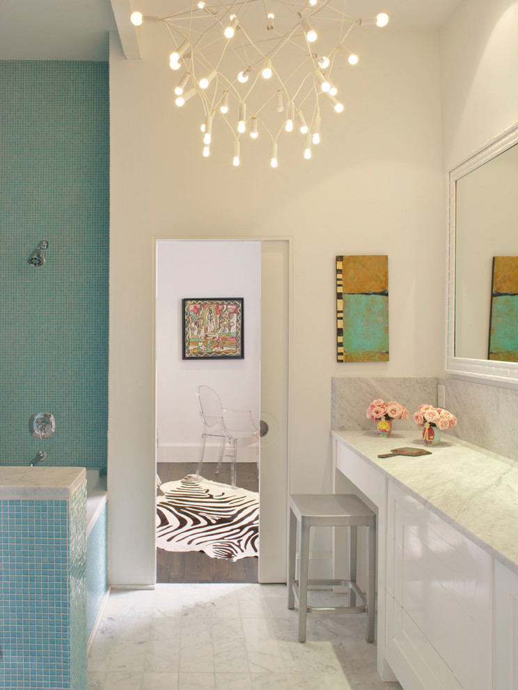 This is an example of a contemporary bathroom in Atlanta with flat-panel cabinets, white cabinets, blue tile, mosaic tile and white walls.