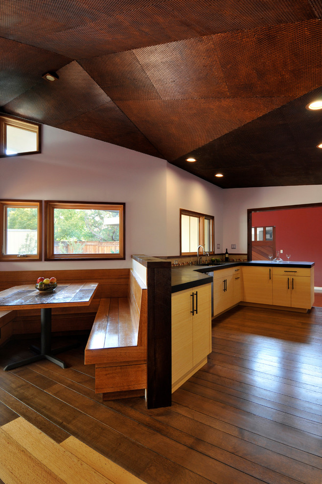 Modern eat-in kitchen in San Francisco with flat-panel cabinets and medium wood cabinets.