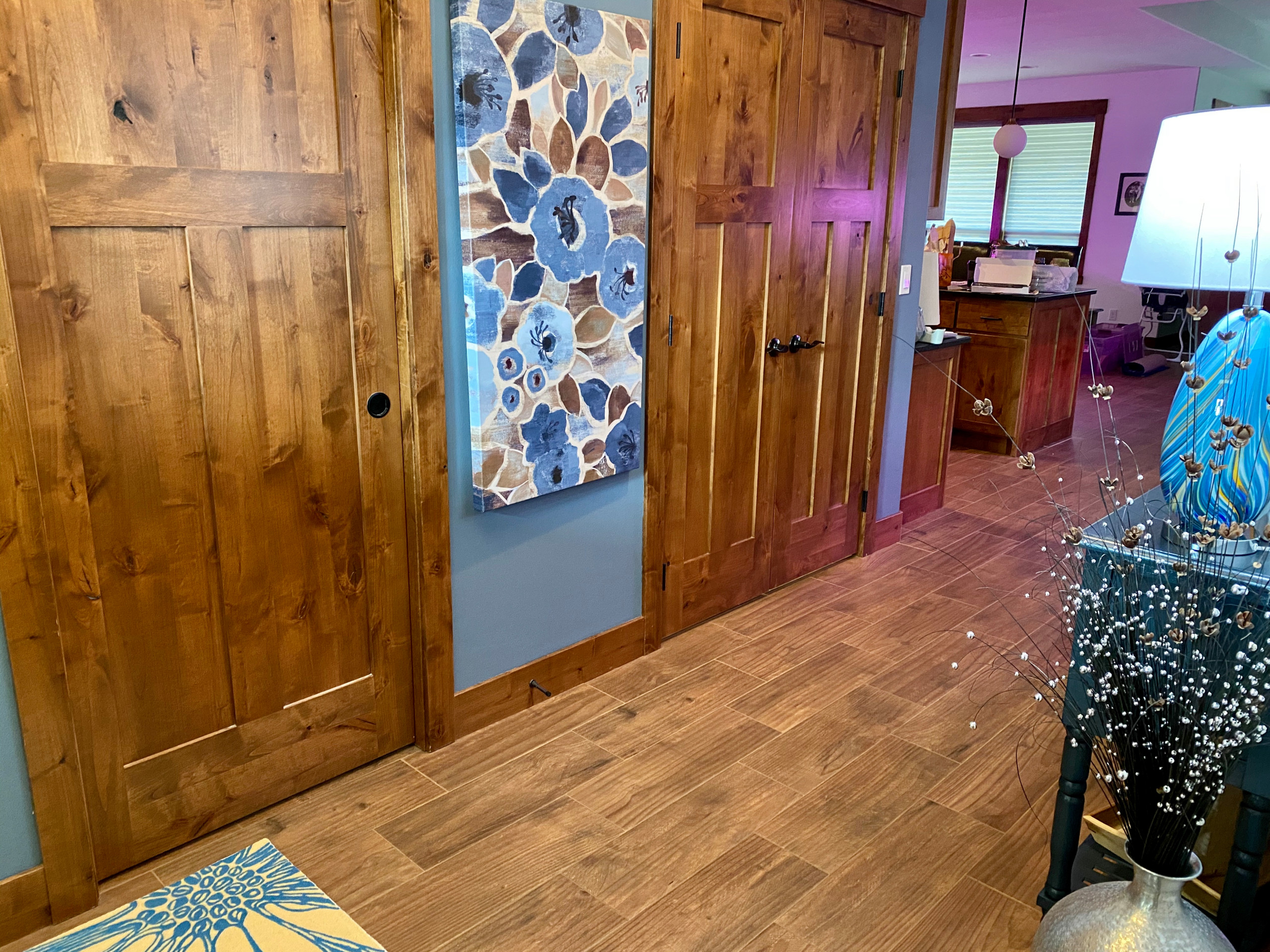 Example of a mid-sized arts and crafts porcelain tile and brown floor entryway design in Other with blue walls and a medium wood front door