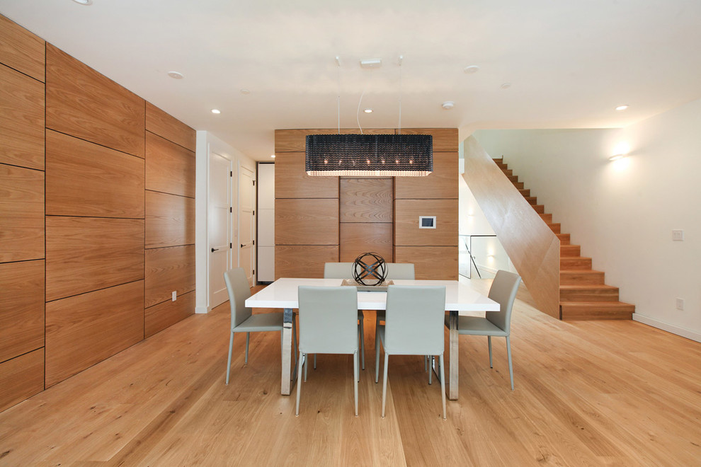 Photo of a contemporary dining room in San Francisco with white walls and medium hardwood floors.