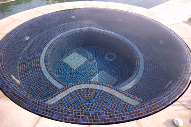 Example of a large transitional backyard custom-shaped and stamped concrete natural hot tub design in San Diego