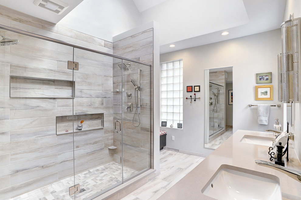 Design ideas for a mid-sized modern master bathroom in Other with a built-in vanity, a double shower, gray tile, porcelain tile, grey walls, porcelain floors, an undermount sink, engineered quartz benchtops, grey floor, a hinged shower door, beige benchtops, a double vanity and recessed.