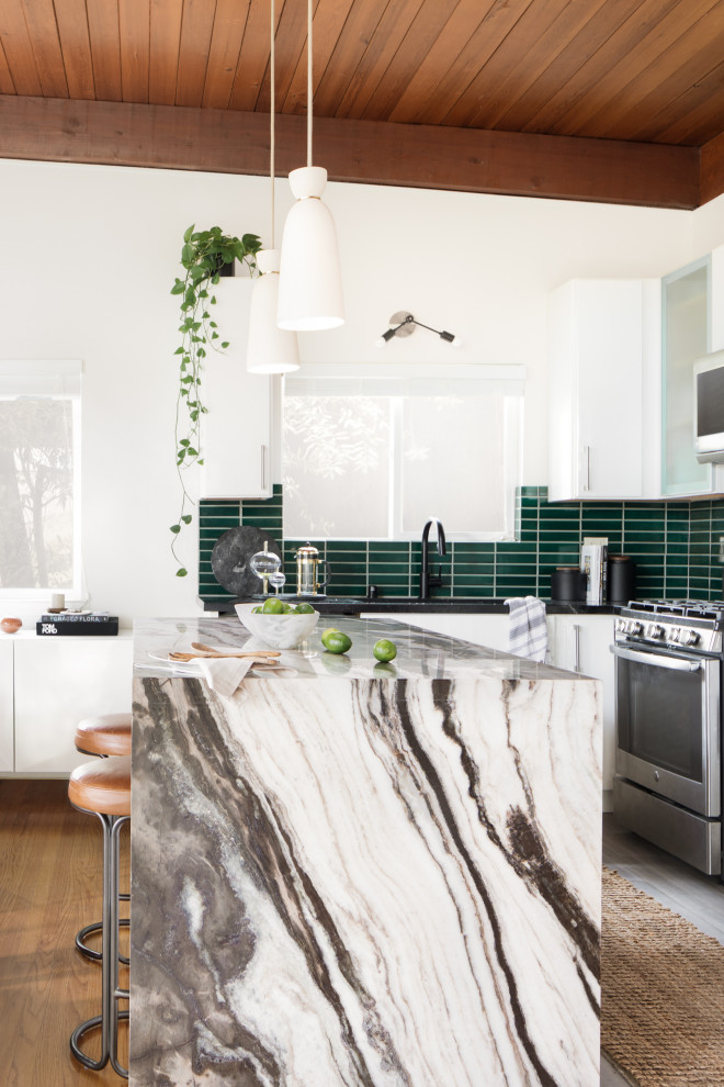 Design ideas for a small midcentury l-shaped open plan kitchen in San Francisco with an undermount sink, flat-panel cabinets, white cabinets, marble benchtops, green splashback, ceramic splashback, stainless steel appliances, with island, black benchtop and exposed beam.
