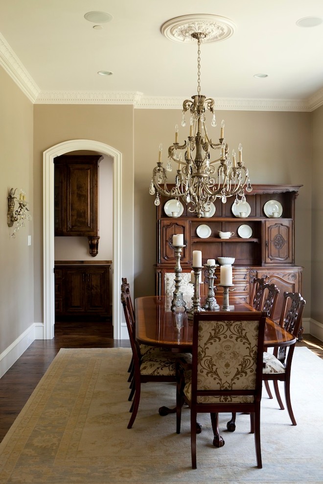 Design ideas for a traditional separate dining room in Dallas with beige walls and dark hardwood floors.