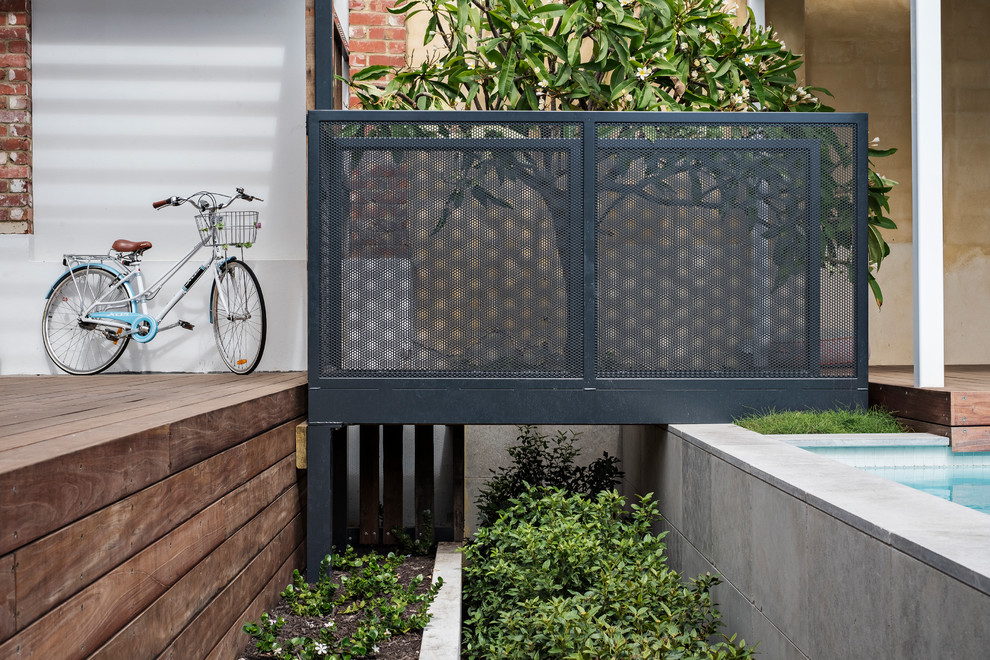 Inspiration for a mid-sized transitional backyard patio in Perth with decking and a pergola.