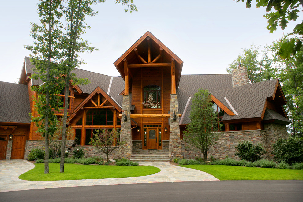 Mountain style front door photo with brown walls and a medium wood front door