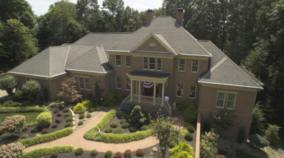 Inspiration for a large traditional two-storey brick brown exterior in Nashville with a hip roof.