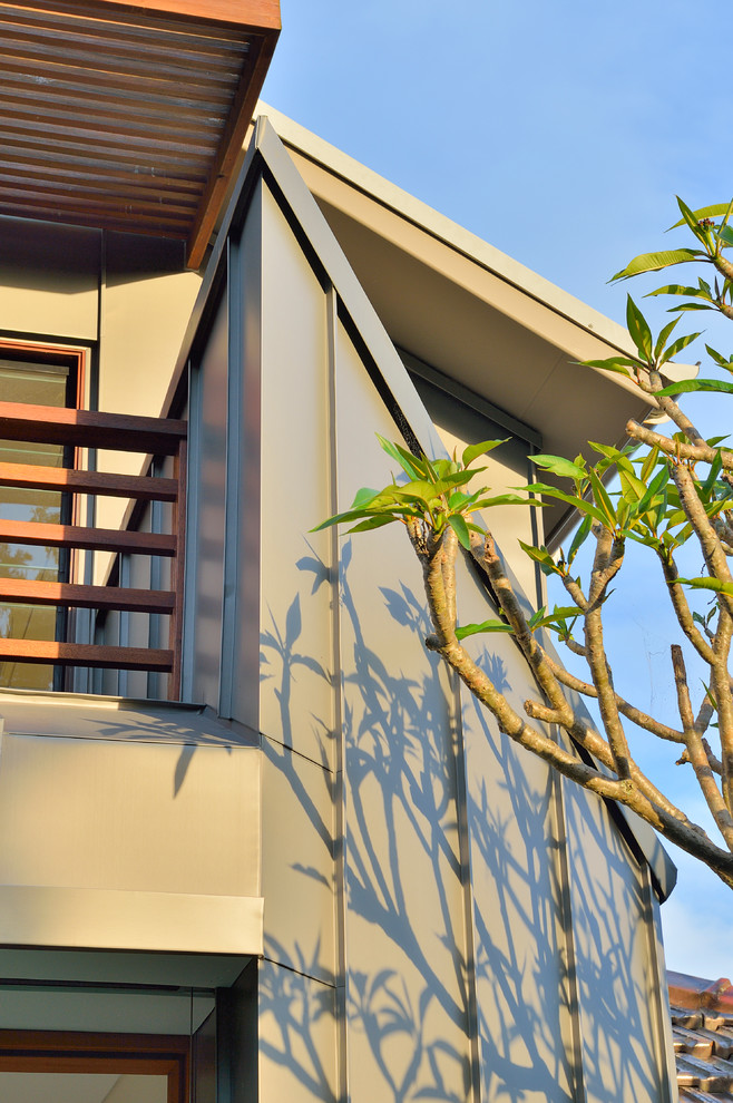 Photo of a large contemporary two-storey grey exterior in Sydney with metal siding and a shed roof.