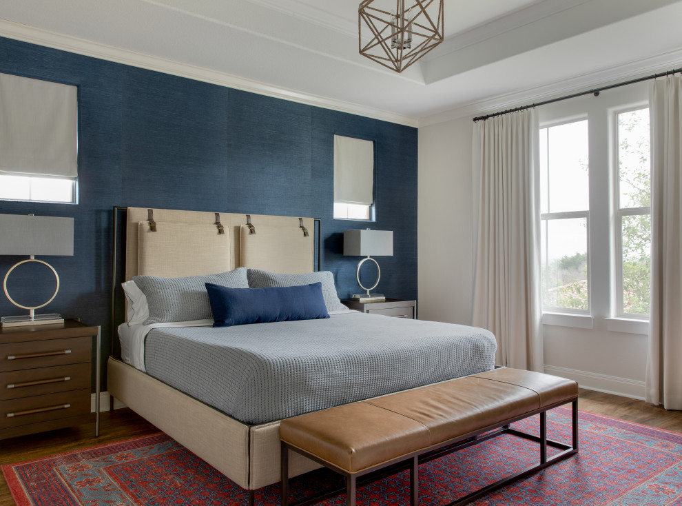 Large transitional master bedroom in Austin with blue walls and wallpaper.