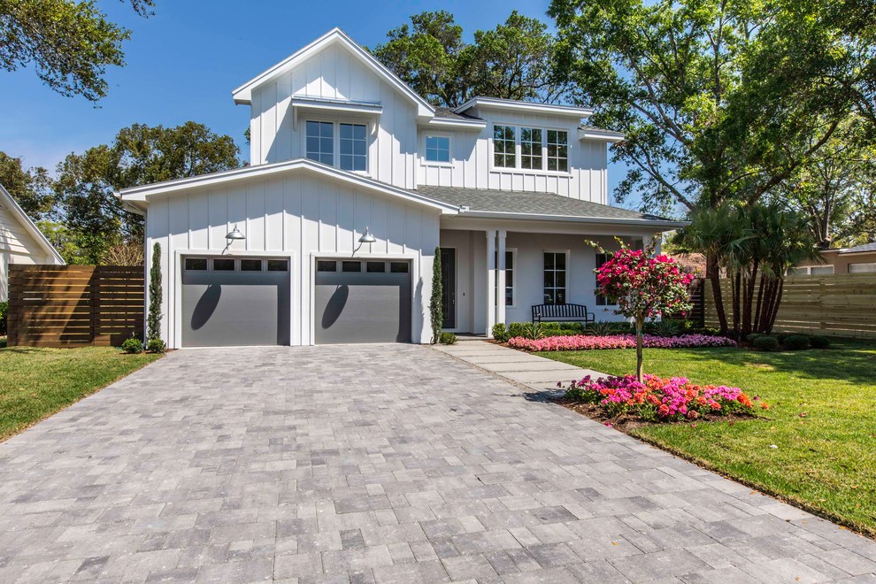 Inspiration for a large country two-storey house exterior in Orlando with mixed siding and a shingle roof.