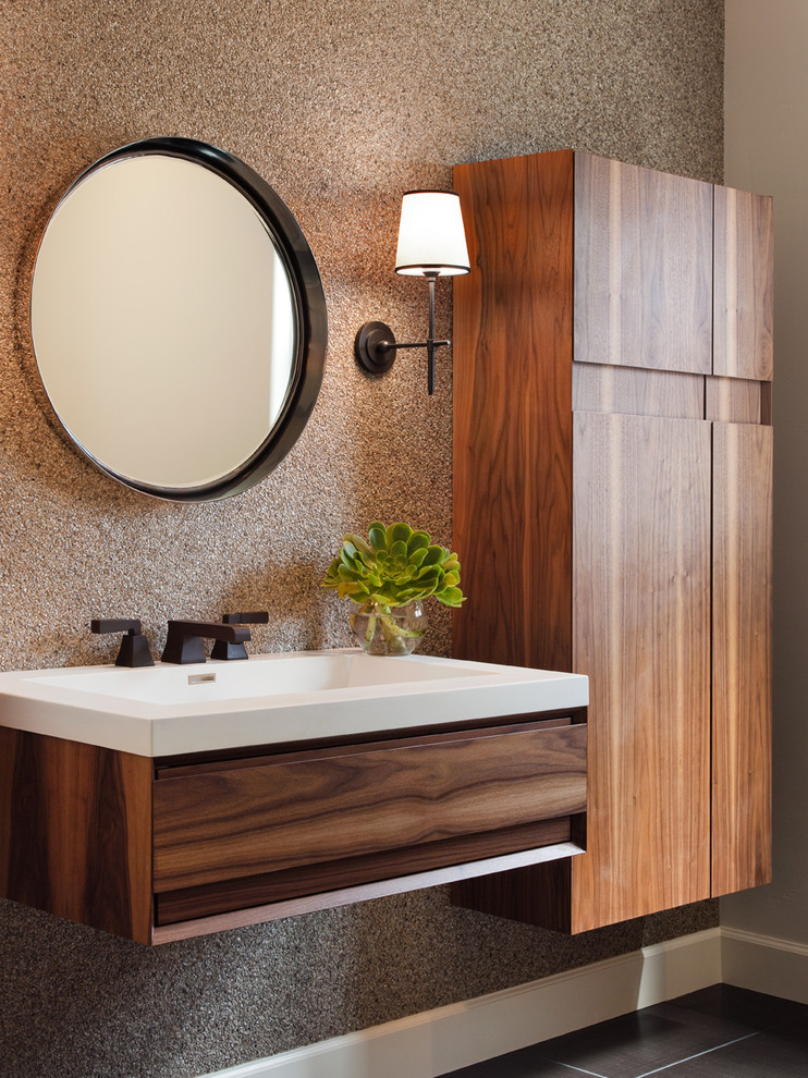 This is an example of a contemporary powder room in San Francisco with flat-panel cabinets, medium wood cabinets and a wall-mount sink.