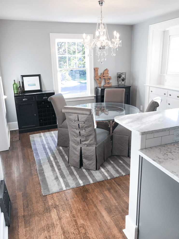 This is an example of a mid-sized traditional kitchen/dining combo in Detroit with grey walls, medium hardwood floors, no fireplace and brown floor.