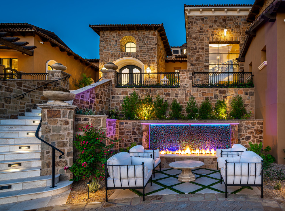 Photo of a patio in Phoenix with with fireplace and no cover.