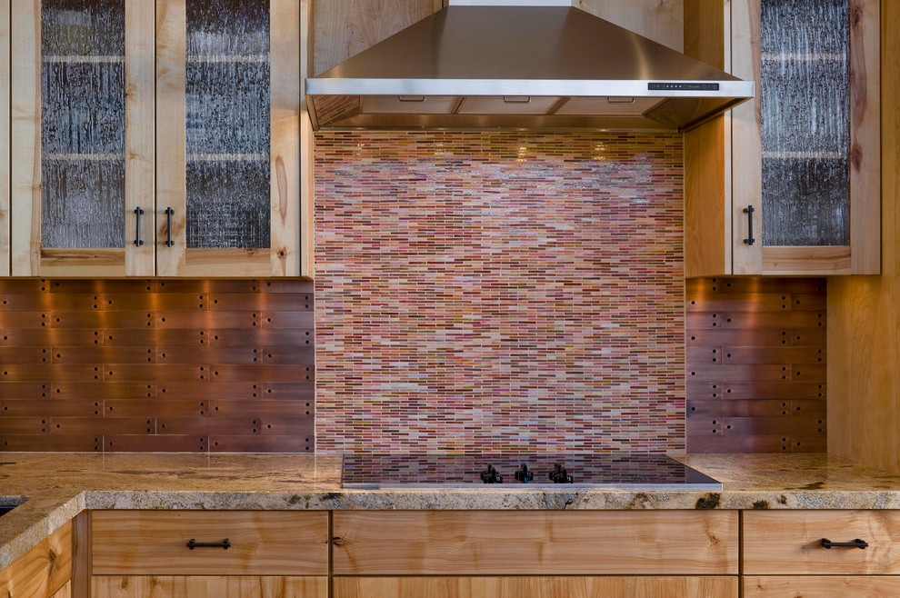 Inspiration for a mid-sized rustic l-shaped medium tone wood floor kitchen remodel with an undermount sink, flat-panel cabinets, light wood cabinets, multicolored backsplash, matchstick tile backsplash, paneled appliances and an island