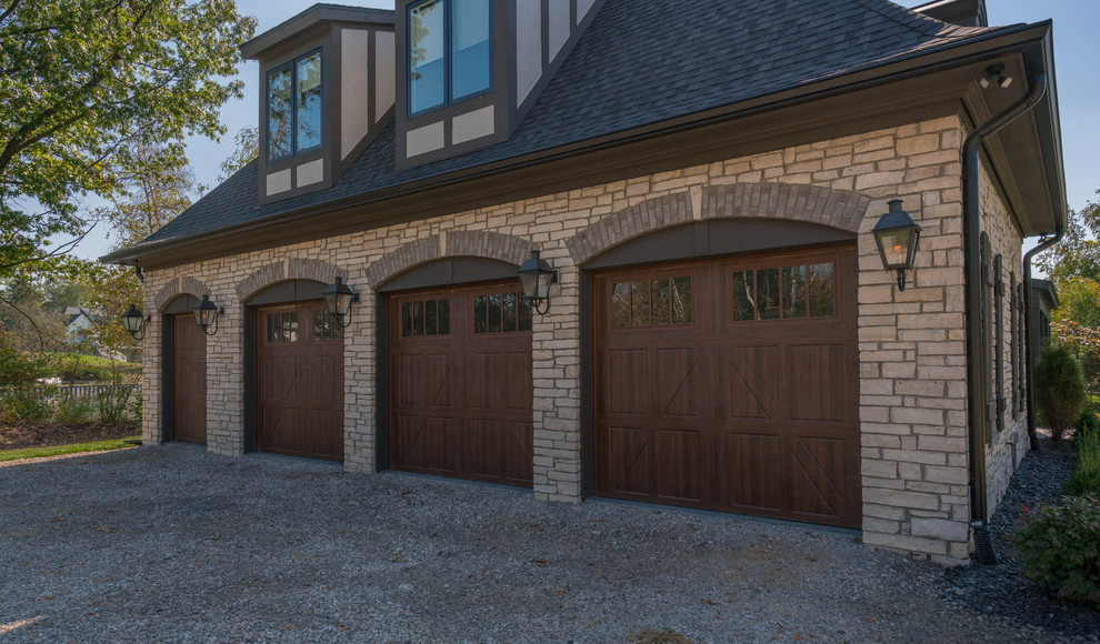 This is an example of an expansive traditional attached four-car garage in Detroit.