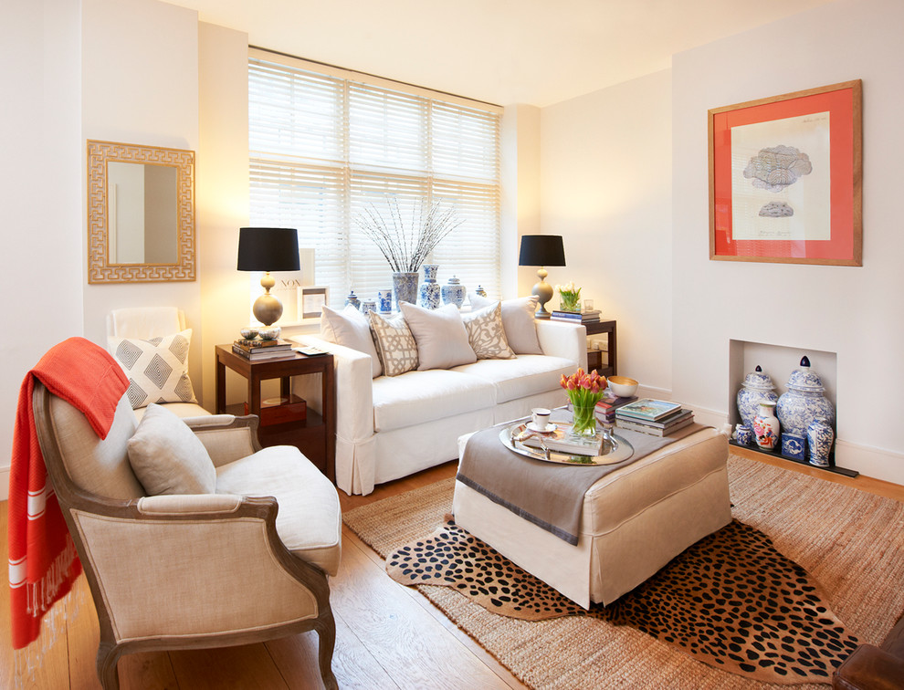 This is an example of a transitional formal living room in London with beige walls.