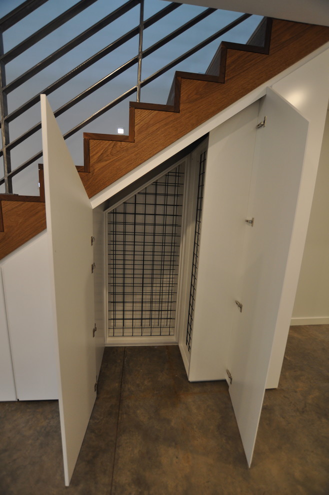 Design ideas for a small contemporary wine cellar in Sydney with storage racks.