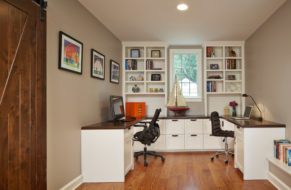 Photo of a mid-sized traditional home office in Chicago with a built-in desk, medium hardwood floors, beige walls, brown floor and no fireplace.
