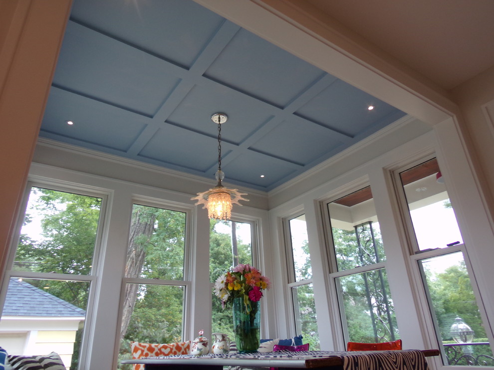 Inspiration for a large transitional u-shaped porcelain tile eat-in kitchen remodel with a farmhouse sink, flat-panel cabinets, gray cabinets, marble countertops, white backsplash, ceramic backsplash, white appliances and no island