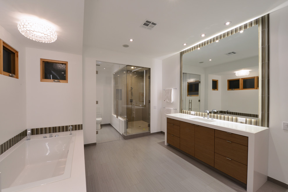 Design ideas for a large modern master bathroom in San Diego with medium wood cabinets, flat-panel cabinets, a drop-in tub, an alcove shower, a two-piece toilet, white walls, an undermount sink, quartzite benchtops and brown floor.