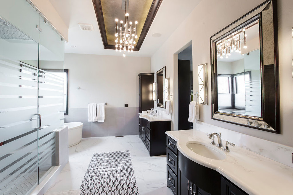 Photo of an expansive mediterranean master bathroom in Denver with furniture-like cabinets, black cabinets, a freestanding tub, a corner shower, white walls, marble floors, a drop-in sink, quartzite benchtops, multi-coloured floor and white benchtops.