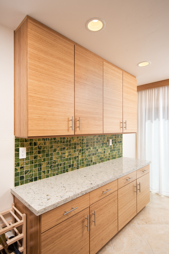 Inspiration for a mid-sized contemporary l-shaped kitchen pantry in San Diego with an undermount sink, flat-panel cabinets, quartz benchtops, green splashback, mosaic tile splashback, stainless steel appliances and porcelain floors.
