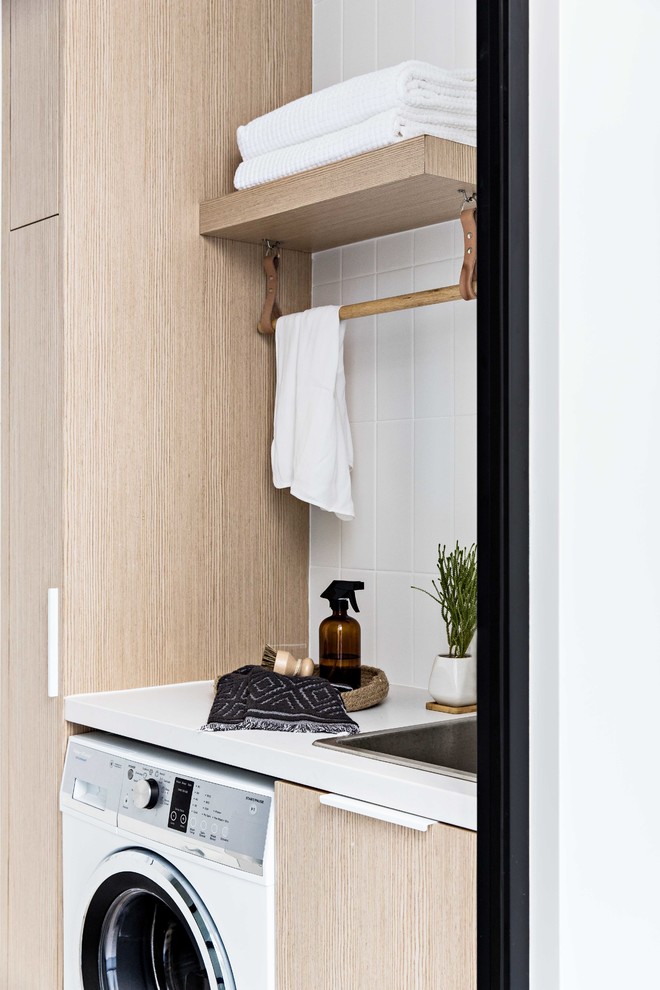 Small contemporary laundry room in Sydney.
