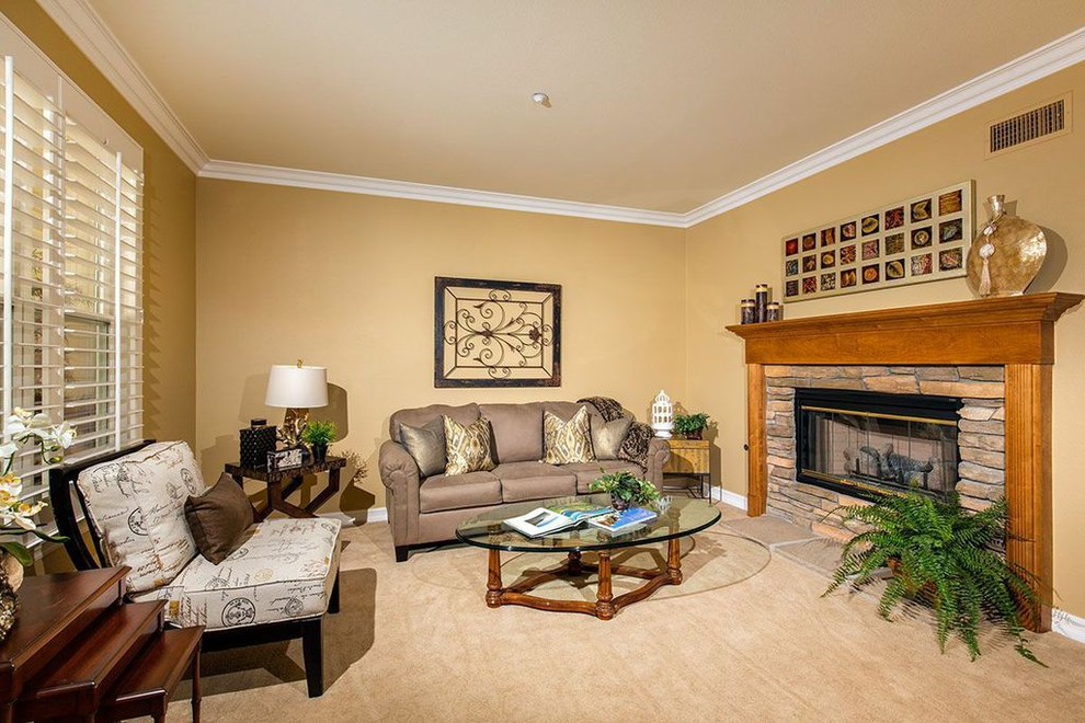 Transitional formal enclosed living room in San Diego with carpet, a standard fireplace and a wood fireplace surround.