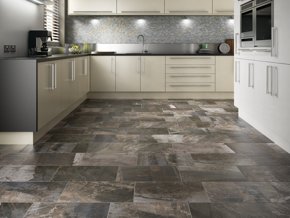 Mid-sized minimalist l-shaped ceramic tile enclosed kitchen photo with an undermount sink, flat-panel cabinets, white cabinets, solid surface countertops, multicolored backsplash, mosaic tile backsplash, stainless steel appliances and no island