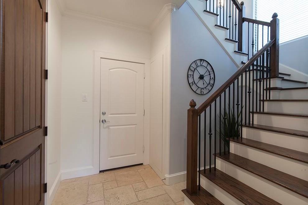 Transitional entryway in Houston with a single front door and a dark wood front door.