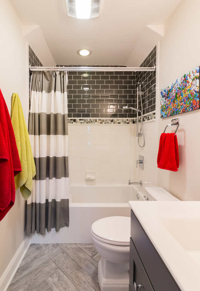 Arts and crafts kids bathroom in Boston with shaker cabinets, grey cabinets, an alcove tub, a shower/bathtub combo, black and white tile, beige walls, porcelain floors, engineered quartz benchtops, grey floor, a shower curtain and white benchtops.