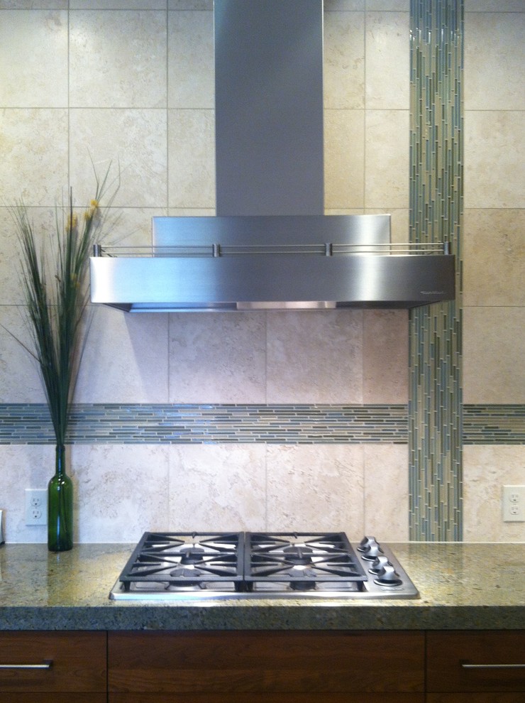 Eat-in kitchen - transitional l-shaped eat-in kitchen idea in Denver with an undermount sink, shaker cabinets, medium tone wood cabinets, granite countertops, beige backsplash, stone tile backsplash and stainless steel appliances