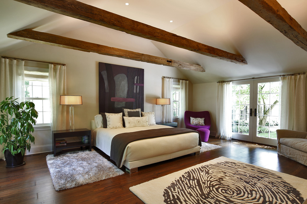 This is an example of a mid-sized contemporary master bedroom in New York with beige walls and dark hardwood floors.