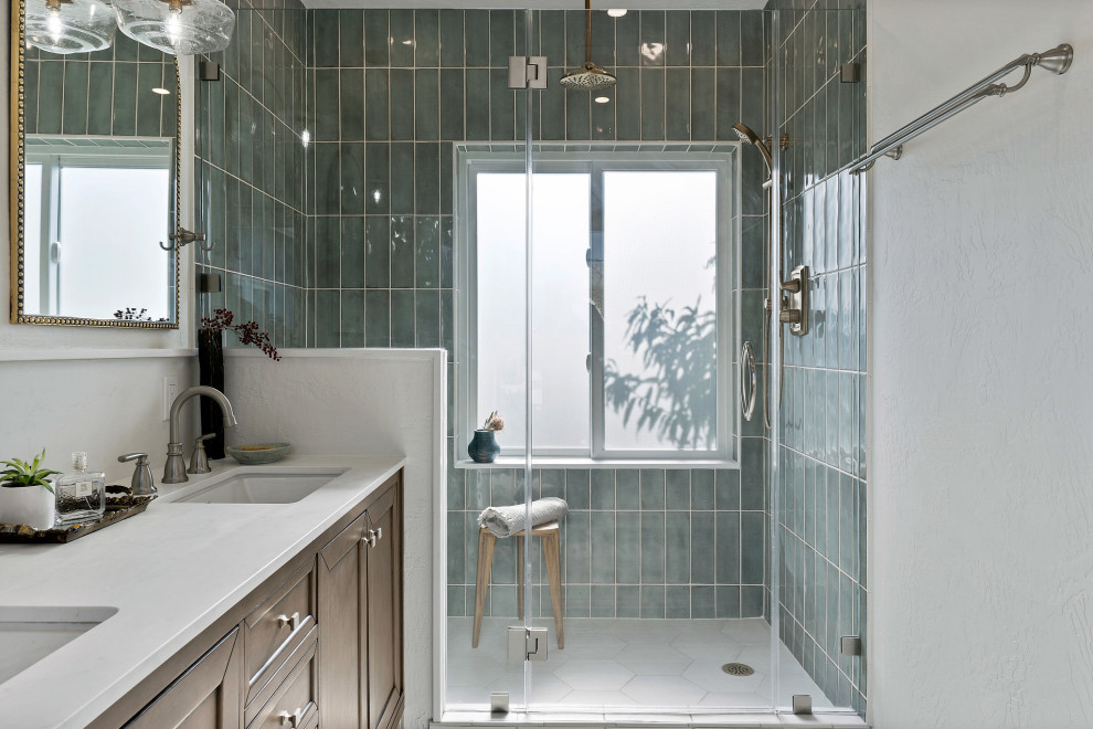 Photo of a medium sized traditional ensuite bathroom in San Francisco with recessed-panel cabinets, brown cabinets, an alcove shower, a two-piece toilet, green tiles, ceramic tiles, white walls, porcelain flooring, a submerged sink, quartz worktops, white floors, a hinged door, white worktops, a shower bench, double sinks and a freestanding vanity unit.