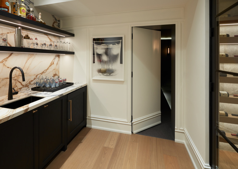 Example of a transitional home bar design in Toronto