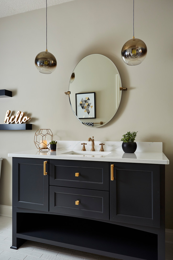 Inspiration for a large country 3/4 bathroom in Minneapolis with recessed-panel cabinets, black cabinets, a two-piece toilet, black and white tile, porcelain tile, brick floors, an undermount sink, engineered quartz benchtops, white floor and beige walls.
