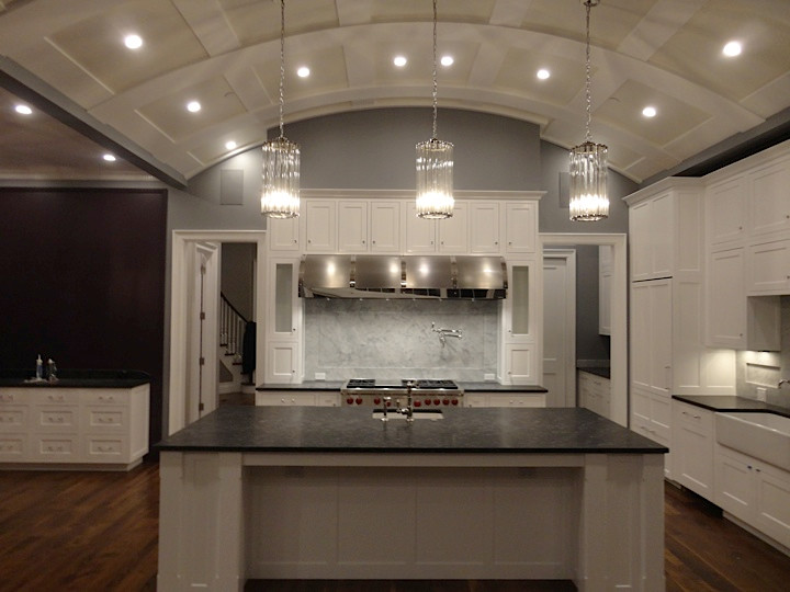 Large transitional l-shaped kitchen photo in Chicago with granite countertops, white cabinets, gray backsplash, stainless steel appliances and an island