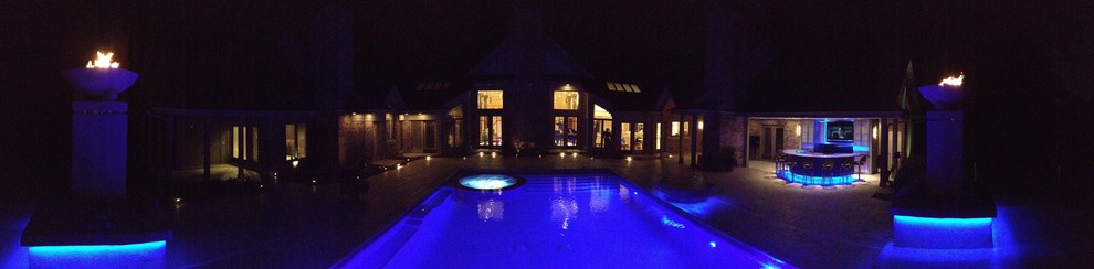 Example of a large transitional backyard concrete paver and rectangular natural hot tub design in Cedar Rapids