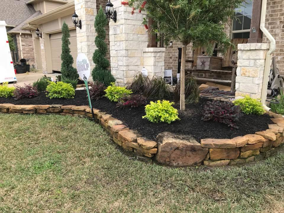 Design ideas for a mid-sized tropical front yard full sun xeriscape for spring in Houston with with flowerbed and natural stone pavers.