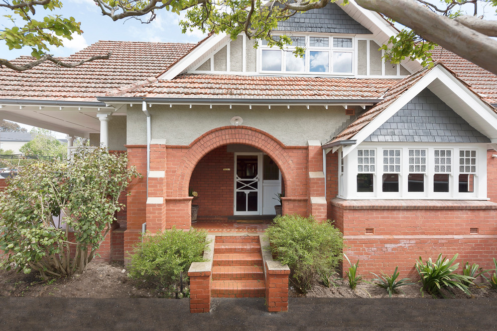 Photo of a large contemporary two-storey brick beige exterior in Melbourne with a gable roof.