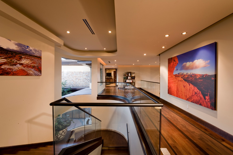 Photo of a contemporary hallway in Las Vegas with beige walls and dark hardwood floors.