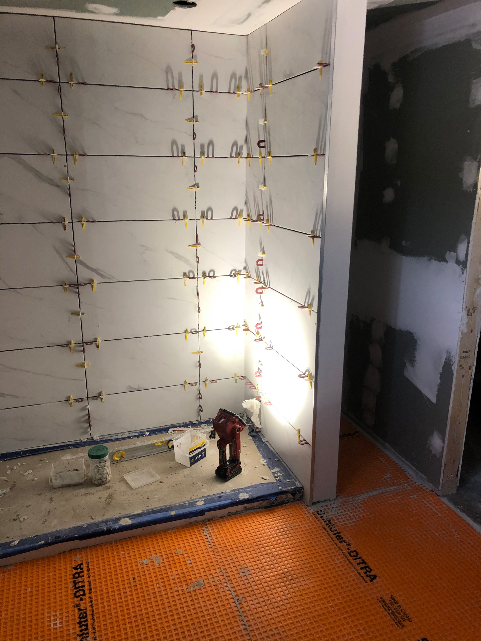 Tile install process including under tile waterproofing