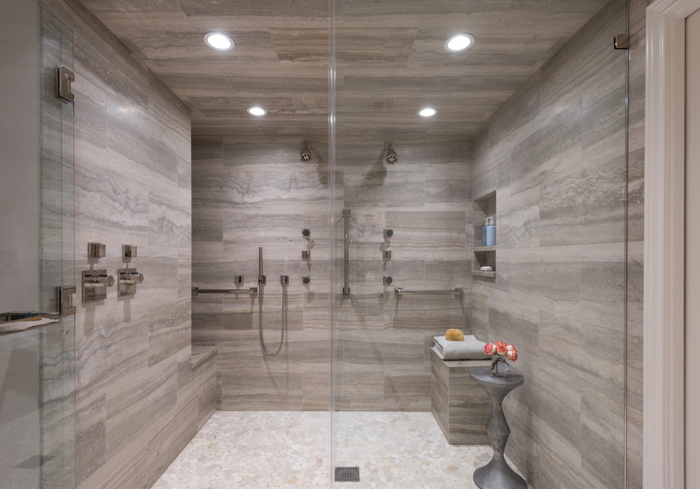 Design ideas for a mid-sized transitional master bathroom in Dallas with shaker cabinets, grey cabinets, a double shower, a two-piece toilet, gray tile, stone tile, grey walls, pebble tile floors, an undermount sink, quartzite benchtops, white floor, a hinged shower door and grey benchtops.